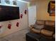 Living room with a large TV, comfortable seating, and decorative accents at 8278 Silverbell Loop, Brooksville, FL 34613