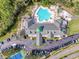 Aerial view of community clubhouse with pool and tennis courts at 9519 Green Needle Dr, New Port Richey, FL 34655