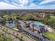 Aerial view of community clubhouse, pool, and tennis courts at 9519 Green Needle Dr, New Port Richey, FL 34655