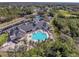 Aerial view of community clubhouse, pool, and tennis courts at 9519 Green Needle Dr, New Port Richey, FL 34655