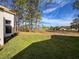 View of backyard with green grass and mature trees at 9519 Green Needle Dr, New Port Richey, FL 34655