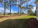 View of backyard showcasing mature trees and golf course view at 9519 Green Needle Dr, New Port Richey, FL 34655