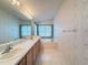 Bathroom boasts double sinks, a bathtub, and updated cabinets at 9519 Green Needle Dr, New Port Richey, FL 34655