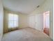 Spacious bedroom with carpet and double door closet at 9519 Green Needle Dr, New Port Richey, FL 34655