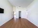 Primary bedroom with wood flooring and access to bathroom and closet at 9519 Green Needle Dr, New Port Richey, FL 34655