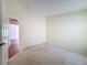 Well-lit bedroom with carpet flooring and access to another room at 9519 Green Needle Dr, New Port Richey, FL 34655