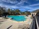 Community pool with plenty of lounge chairs and umbrellas at 9519 Green Needle Dr, New Port Richey, FL 34655