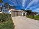 Front view of house, showing garage and landscaping at 9519 Green Needle Dr, New Port Richey, FL 34655