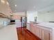 Bright kitchen with wood flooring, stainless steel appliances, and ample cabinetry at 9519 Green Needle Dr, New Port Richey, FL 34655