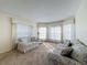 Bright living room with bay windows and floral sofas at 9519 Green Needle Dr, New Port Richey, FL 34655