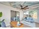 Bright sunroom with painted ceiling, workspace, and access to bedroom and backyard at 101 Hillcrest Dr, Safety Harbor, FL 34695