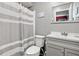 Second bathroom with updated vanity and gray shower curtain at 10620 Salamanca Dr, Port Richey, FL 34668
