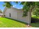Side view of house showcasing additional building and landscaping at 10620 Salamanca Dr, Port Richey, FL 34668