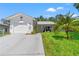 White house with green lawn, palm tree, and driveway at 10620 Salamanca Dr, Port Richey, FL 34668
