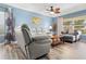 Relaxing living room with light gray reclining sofas and wood-look floors at 10620 Salamanca Dr, Port Richey, FL 34668