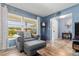 Living room with comfy chair, ottoman, and hardwood floors at 10620 Salamanca Dr, Port Richey, FL 34668