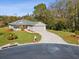 Aerial view of a single-story house with a large yard and driveway at 11509 Sinatra Ct, New Port Richey, FL 34654
