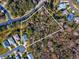 Aerial view of a vacant lot surrounded by trees and houses at 11509 Sinatra Ct, New Port Richey, FL 34654