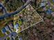 Aerial view of a property with surrounding houses and lot line at 11509 Sinatra Ct, New Port Richey, FL 34654