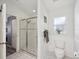 Clean bathroom with shower and toilet, and access to bedroom at 11509 Sinatra Ct, New Port Richey, FL 34654