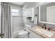 Clean bathroom with granite vanity, shower/tub combo, and white cabinets at 11509 Sinatra Ct, New Port Richey, FL 34654