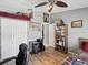 Bedroom with wood floors, a desk, and ample closet space at 11509 Sinatra Ct, New Port Richey, FL 34654