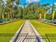 Well-maintained bocce ball courts with green artificial turf and shaded seating areas at 11509 Sinatra Ct, New Port Richey, FL 34654