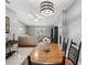 Dining area with wood table and chairs, open to living room at 11509 Sinatra Ct, New Port Richey, FL 34654