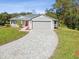 Single story home with gray siding, red door, and a paver driveway at 11509 Sinatra Ct, New Port Richey, FL 34654