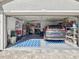 Two-car garage with ample storage shelving and space for two vehicles at 11509 Sinatra Ct, New Port Richey, FL 34654