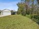 Single story home with a large yard and side view of the house at 11509 Sinatra Ct, New Port Richey, FL 34654