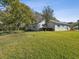 Single story house with large yard, mature trees, and landscaping at 11509 Sinatra Ct, New Port Richey, FL 34654