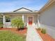 Home's front entrance with a welcoming walkway and landscaping at 11509 Sinatra Ct, New Port Richey, FL 34654