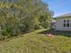 Backyard view showcasing a fire pit and large green lawn at 11509 Sinatra Ct, New Port Richey, FL 34654