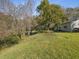 Single-story home with a backyard, lush lawn and mature trees at 11509 Sinatra Ct, New Port Richey, FL 34654