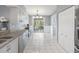 Kitchen with granite countertops, white cabinets, and access to screened porch at 11509 Sinatra Ct, New Port Richey, FL 34654