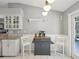Kitchen breakfast nook with gray island and white cabinets at 11509 Sinatra Ct, New Port Richey, FL 34654