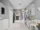 Spacious kitchen boasts granite counters, white cabinets, and stainless steel appliances at 11509 Sinatra Ct, New Port Richey, FL 34654