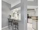 Kitchen breakfast bar with granite countertop and seating for two at 11509 Sinatra Ct, New Port Richey, FL 34654