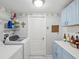 Laundry room with washer, dryer, cabinets, and shelving at 11509 Sinatra Ct, New Port Richey, FL 34654