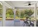 Spacious screened porch with ceiling fan and backyard view at 11509 Sinatra Ct, New Port Richey, FL 34654