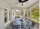 Screened porch with table and chairs, overlooking backyard at 11509 Sinatra Ct, New Port Richey, FL 34654