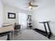 Home office with corner desk, treadmill, and ample natural light at 12085 Petrel Ave, Brooksville, FL 34614