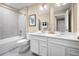 Double vanity bathroom with a large mirror and a white vanity at 12466 Amber Creek Cir, Lakewood Ranch, FL 34211
