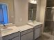 Double vanity bathroom with quartz countertops and a shower at 12466 Amber Creek Cir, Lakewood Ranch, FL 34211
