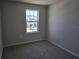 Spacious bedroom featuring a large window and neutral walls at 12466 Amber Creek Cir, Lakewood Ranch, FL 34211