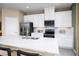Modern kitchen with stainless steel appliances and white cabinetry at 12466 Amber Creek Cir, Lakewood Ranch, FL 34211