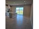 Open concept kitchen with island, sliding door to patio, and tile flooring at 12466 Amber Creek Cir, Lakewood Ranch, FL 34211