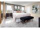 Spacious main bedroom with plush bedding and a stylish bench at the foot of the bed at 12466 Amber Creek Cir, Lakewood Ranch, FL 34211