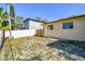 Backyard with fence and partial view of neighbor's house at 1314 Vermont Ave, Tarpon Springs, FL 34689